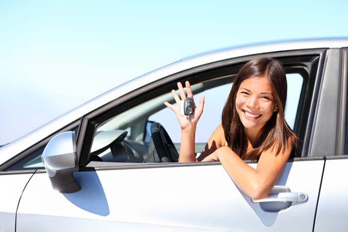 Woman smiling in car rented in Summerside